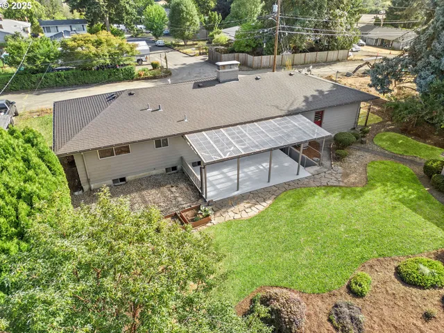 an aerial view of a house with swimming pool garden and patio