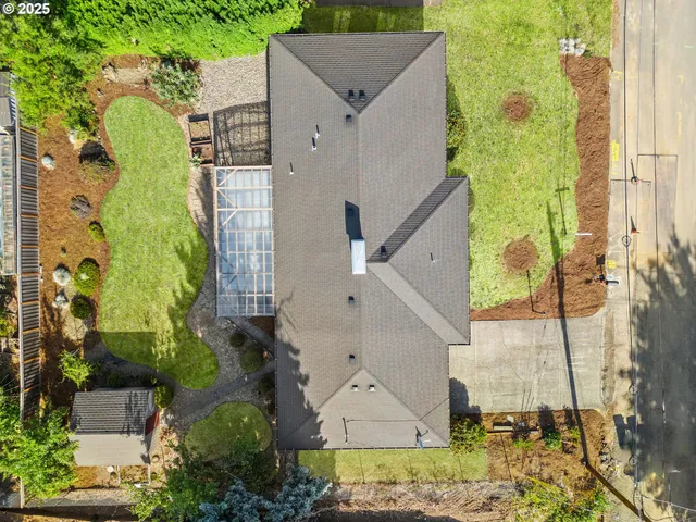 an aerial view of a house with a yard