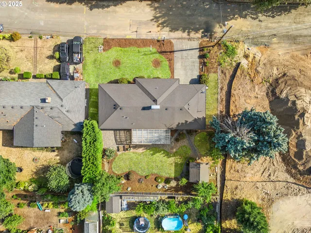 an aerial view of a house with a yard basket ball court and outdoor seating