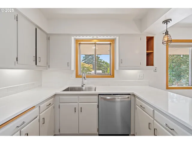 a kitchen with a sink and window