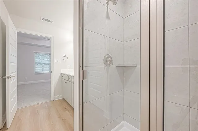 a bathroom with a shower and a sink