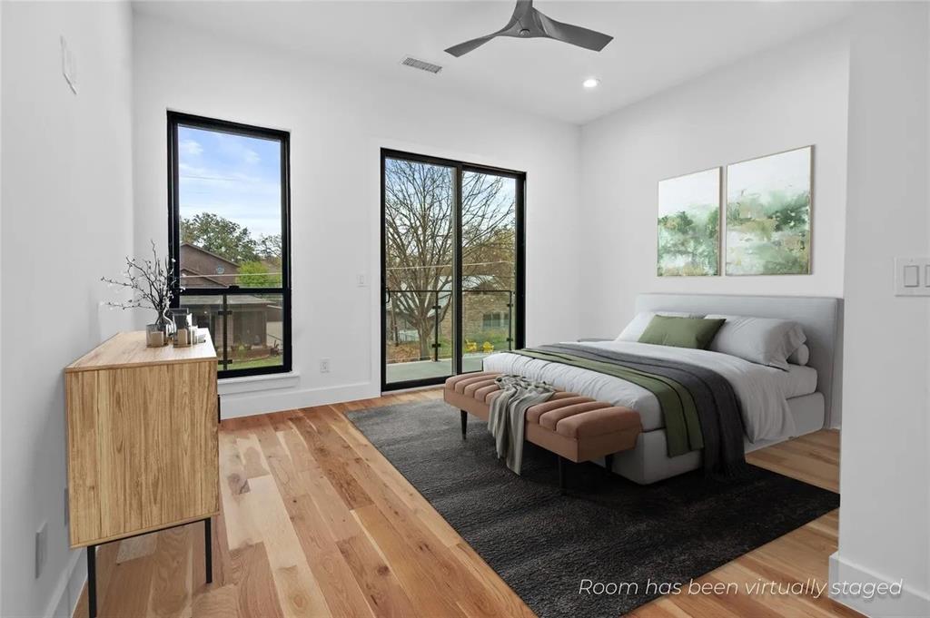 309 Kaye Street Coppell, TX 75019 - Photo 23 of 36 Bright room featuring wide plank wood-finish flooring, a modern ceiling fan, recessed lighting, and a full-height glass door opening to an exterior balcony