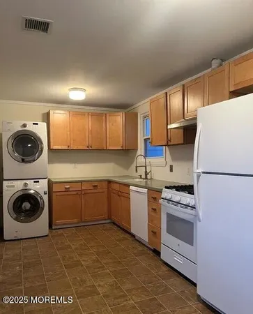 a kitchen with a stove top oven sink and cabinets