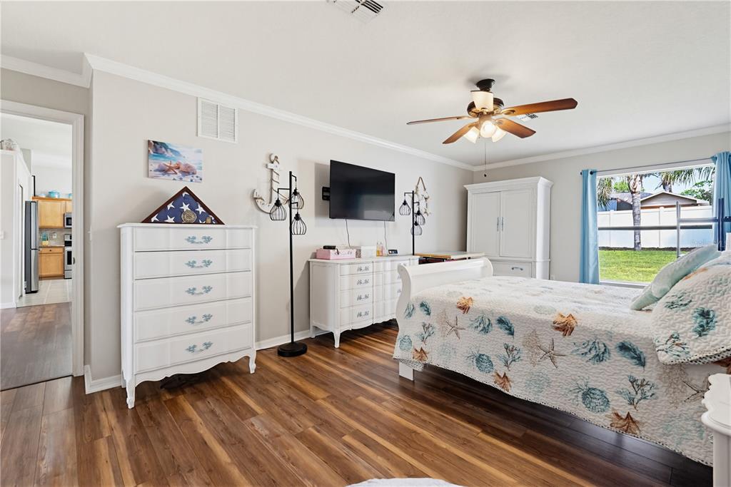 3497 Chadwick Avenue Spring Hill, FL 34609 - Photo 24 of 47 a bedroom with a bed and a flat tv screen on dresser