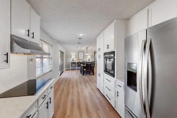 a kitchen with stainless steel appliances a refrigerator and a stove