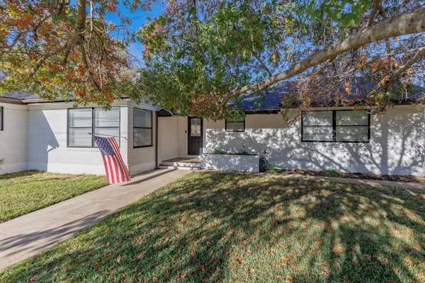 a backyard of a house with barbeque oven