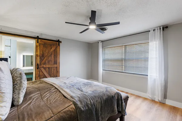 a bedroom with a bed and a window