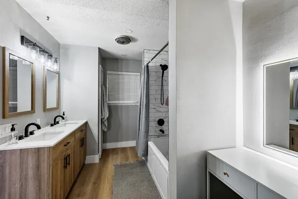 a bathroom with a double vanity sink and mirror