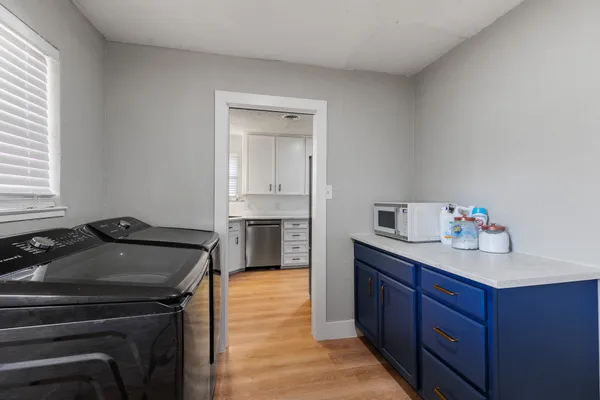 a kitchen with a sink stove and cabinets