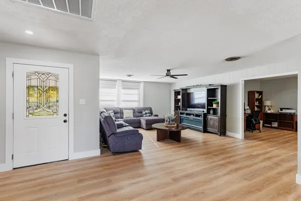 a living room with furniture and a wooden floor