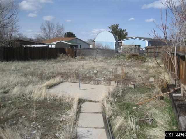 16175 Rhyolite Circle Reno, NV 89521 - Photo 5 of 8 a backyard of a house with table and chairs