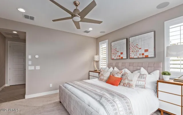 a bedroom with a large bed and a chandelier