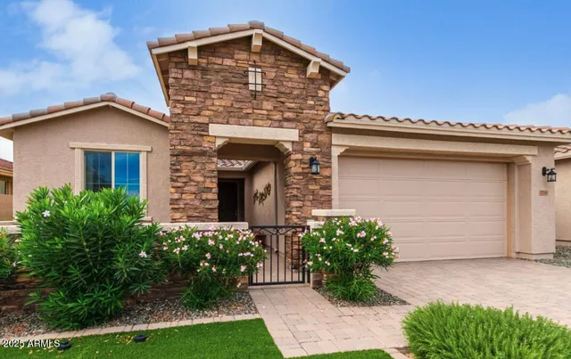 a front view of a house with a garden