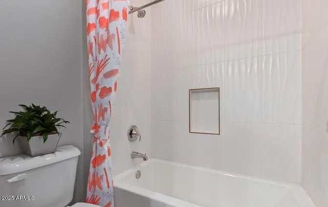 a bath tub sitting next to a white toilet