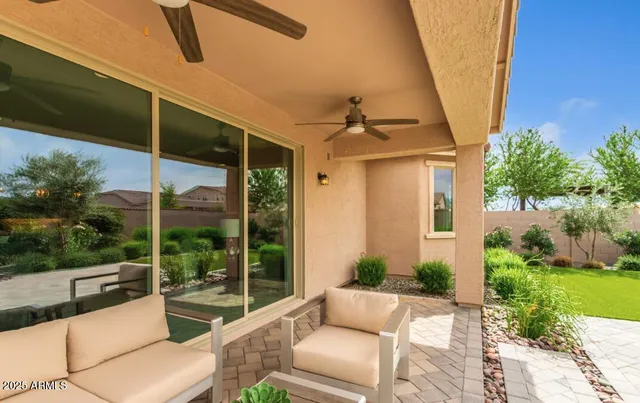 a view of a patio with couches chairs and potted plants