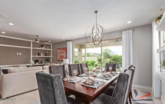 a view of a dining room with furniture wooden floor and chandelier