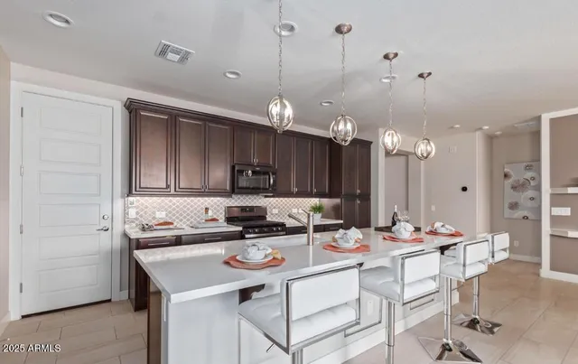 a kitchen with a sink refrigerator and cabinets