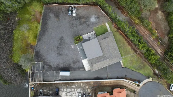 an aerial view of a house with a yard