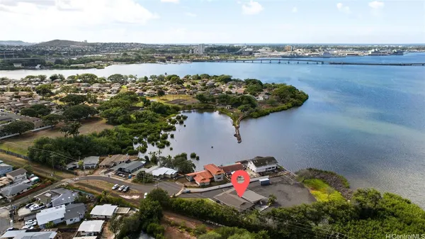 an aerial view of a house with a lake view