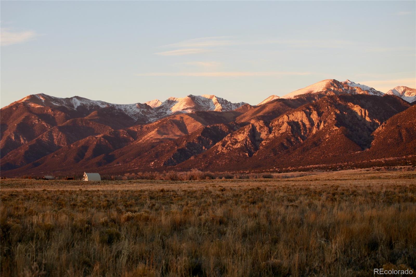 620-621 Pine Cone Road Crestone, CO 81131 - Photo 13 of 16 a view of a large building with a mountain in the background