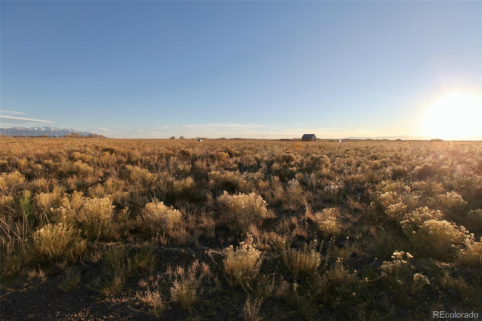 620-621 Pine Cone Road Crestone, CO 81131 - Photo 7 of 16 an aerial view of house with yard and mountain view in back