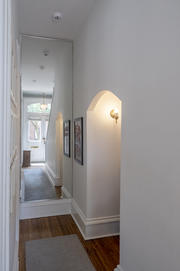 558 West Belden Avenue Chicago, IL 60614 - Photo 13 of 62 a view of a hallway with wooden floor and staircase