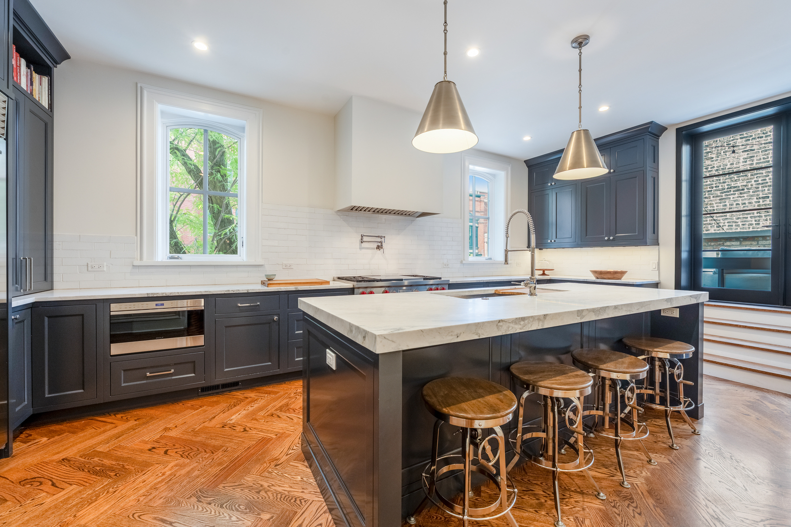 558 West Belden Avenue Chicago, IL 60614 - Photo 20 of 62 a kitchen with stainless steel appliances granite countertop a stove a refrigerator and a kitchen island