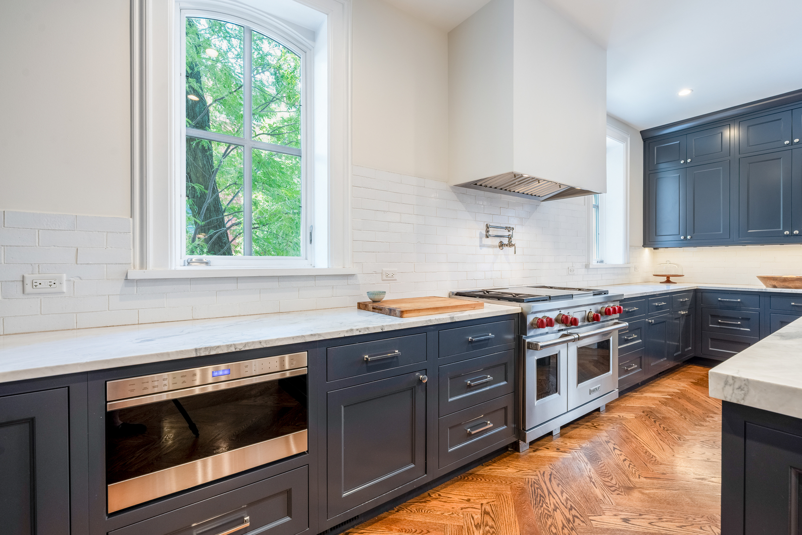 558 West Belden Avenue Chicago, IL 60614 - Photo 24 of 62 a kitchen with stainless steel appliances granite countertop a stove and a sink