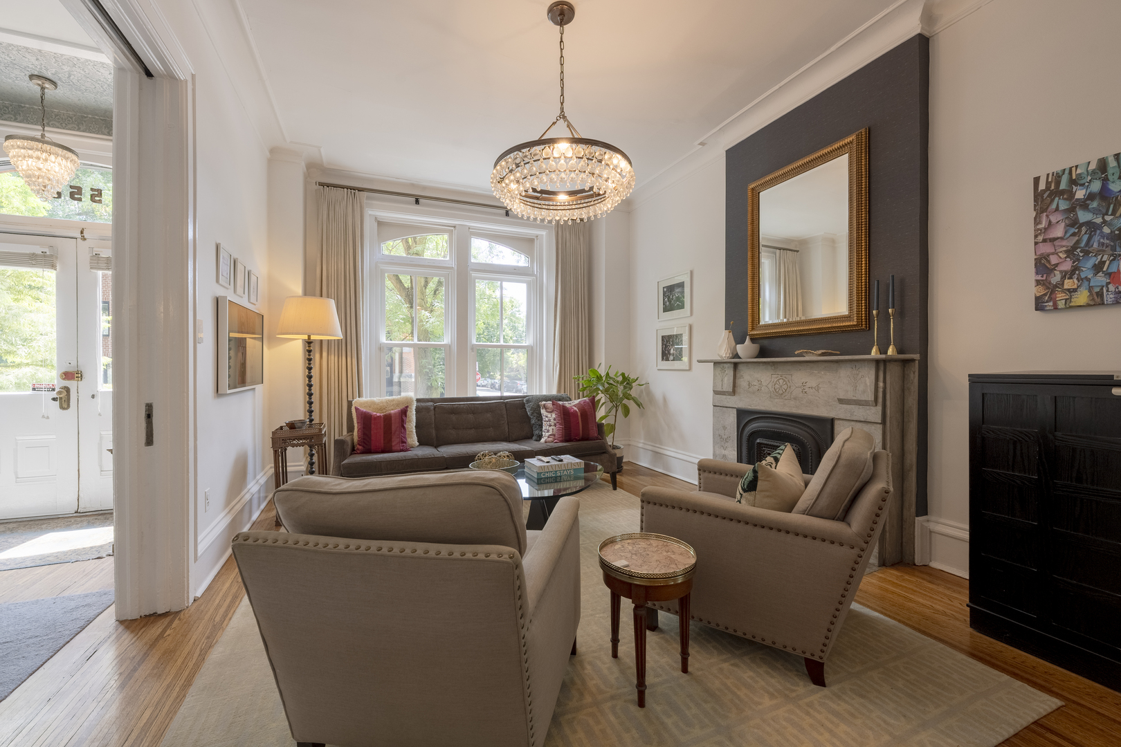 558 West Belden Avenue Chicago, IL 60614 - Photo 8 of 62 a living room with furniture a fireplace and a chandelier