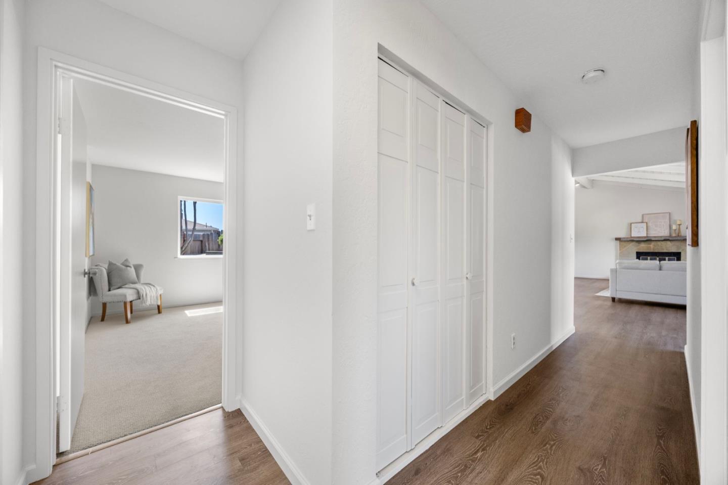 9310 Canyon Oak Road Salinas, CA 93907 - Photo 37 of 81 a view of a hallway with white furniture and wooden floor