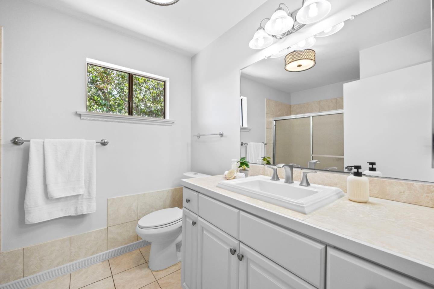 9310 Canyon Oak Road Salinas, CA 93907 - Photo 44 of 81 a bathroom with a granite countertop sink a toilet and a mirror