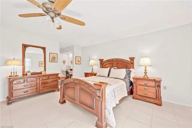 a bedroom with a bed and ceiling fan