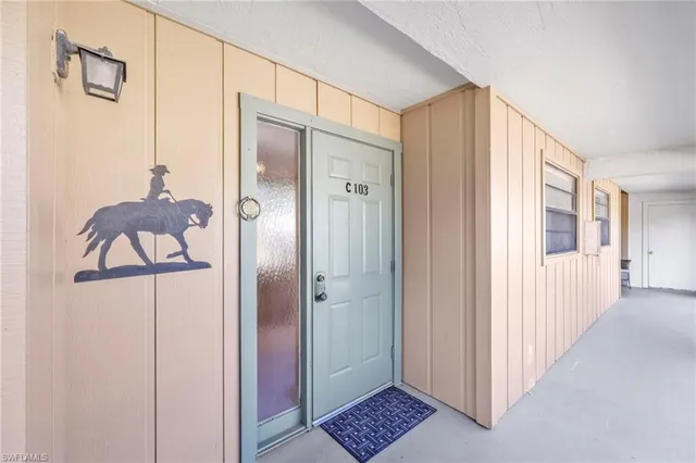 a bathroom with a glass shower door and a window