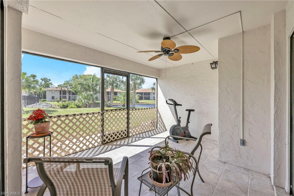 151 Cypress Way East, Unit C103 Naples, FL 34110 - Photo 24 of 29 a bedroom with furniture window and outside view