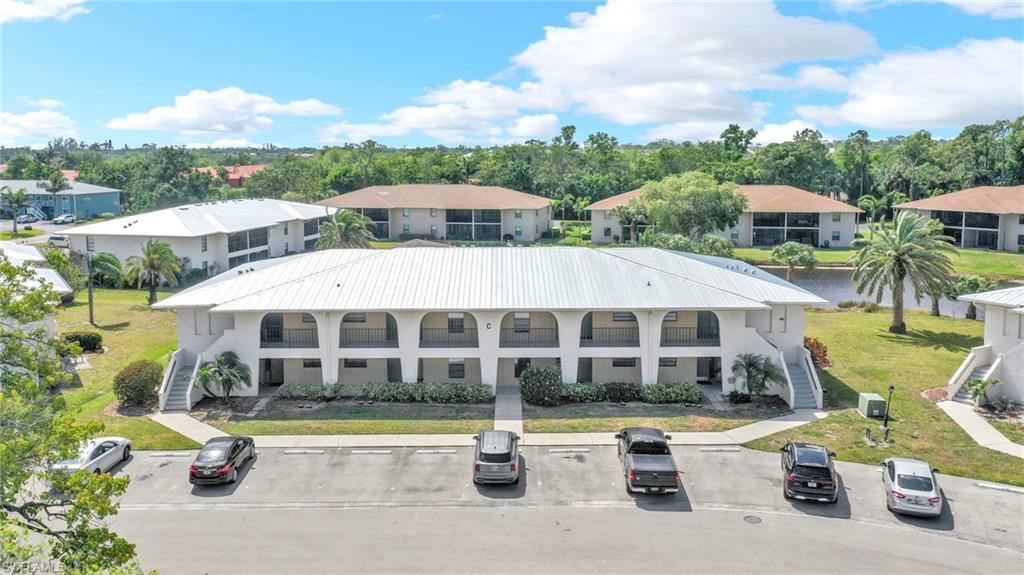 151 Cypress Way East, Unit C103 Naples, FL 34110 - Photo 28 of 29 a front view of a building with street view