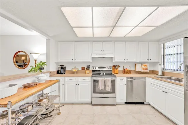 a kitchen with a stove a sink and a microwave