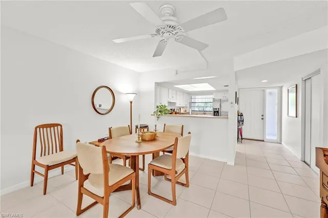 a dining room with furniture and a view of kitchen