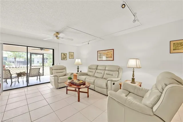 a living room with furniture and a lamp with wooden floor