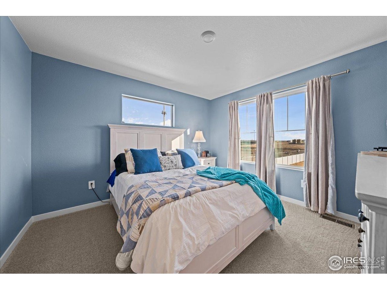 341 Cardinal Street Johnstown, CO 80534 - Photo 9 of 21 a bedroom with a bed and a large mirror