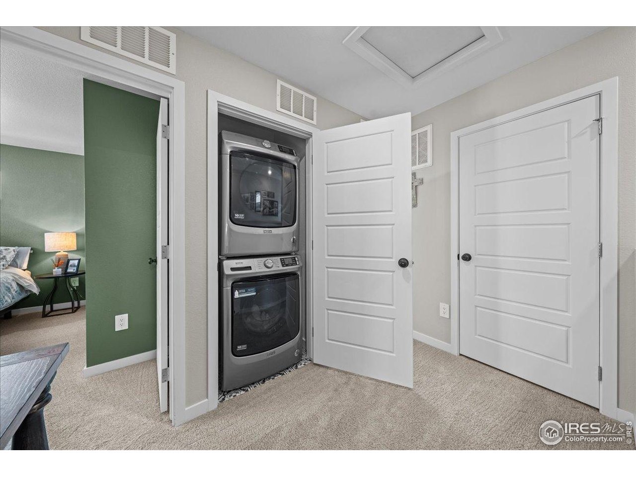 341 Cardinal Street Johnstown, CO 80534 - Photo 16 of 21 a living room with furniture and a refrigerator