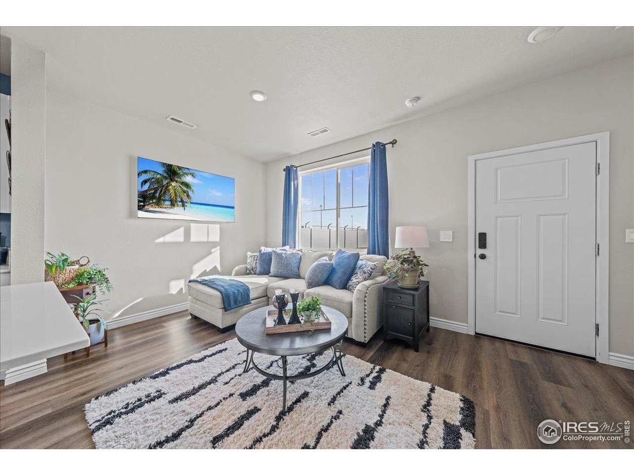 341 Cardinal Street Johnstown, CO 80534 - Photo 5 of 21 a living room with furniture and wooden floor