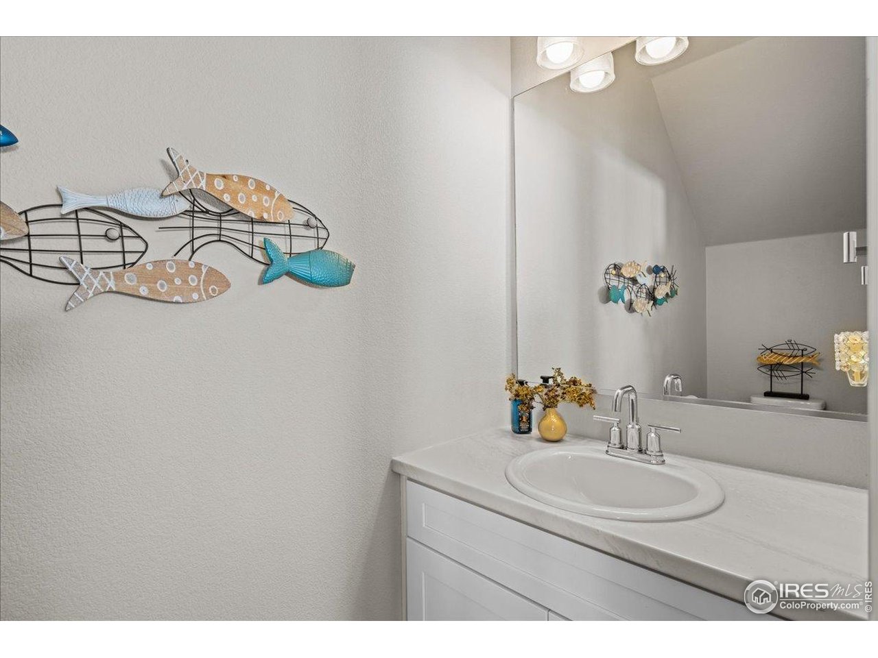 341 Cardinal Street Johnstown, CO 80534 - Photo 8 of 21 a bathroom with a sink and a mirror