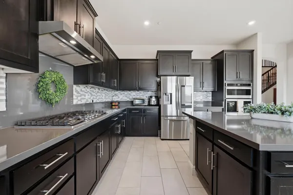 a kitchen with stainless steel appliances granite countertop a sink counter space and cabinets