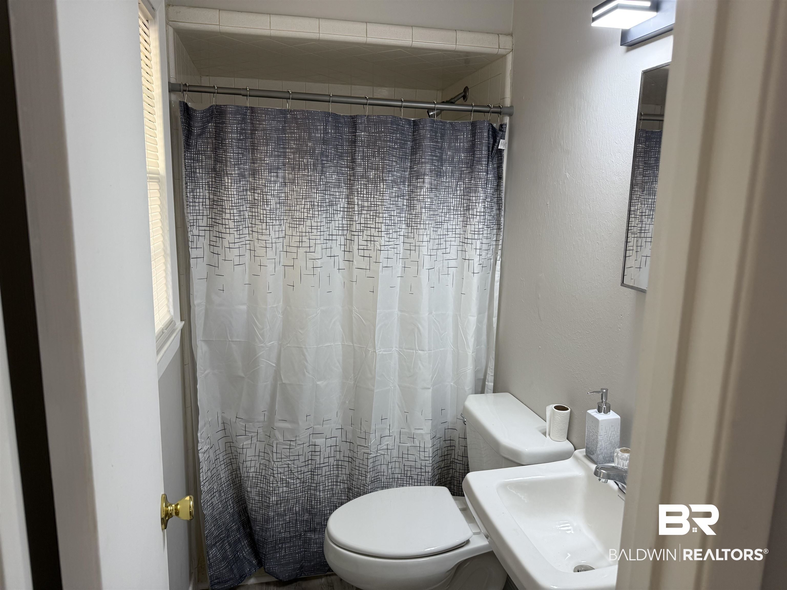 114 Spruce Avenue Brewton, AL 36426 - Photo 10 of 13 Full bathroom featuring a shower with shower curtain