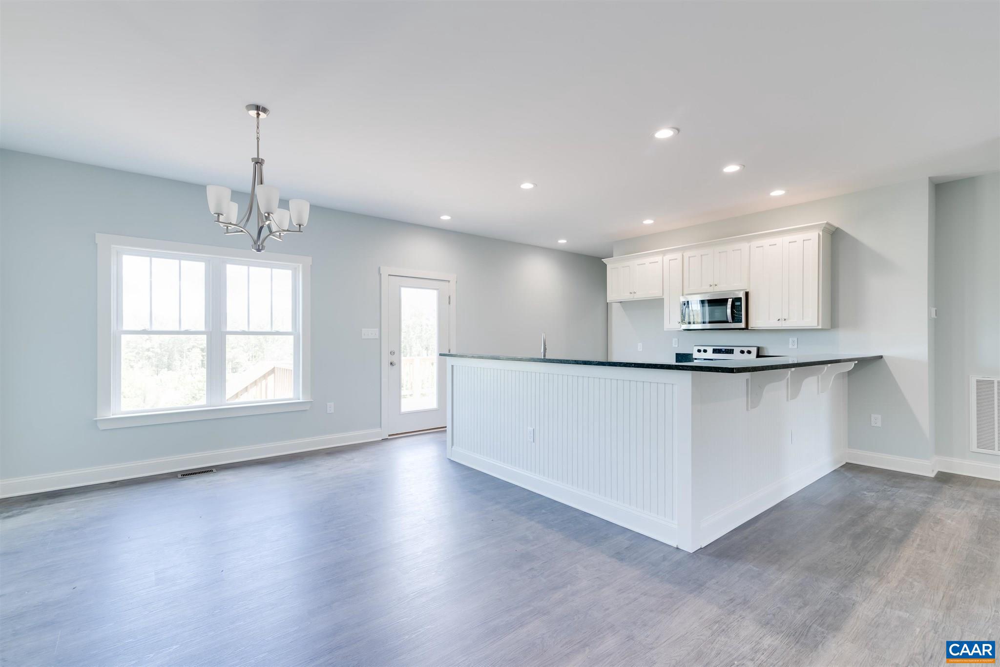 6008 Old Columbia Road Columbia, VA 23038 - Photo 5 of 23 a view of kitchen with stainless steel appliances granite countertop a white stove top oven and a chandelier