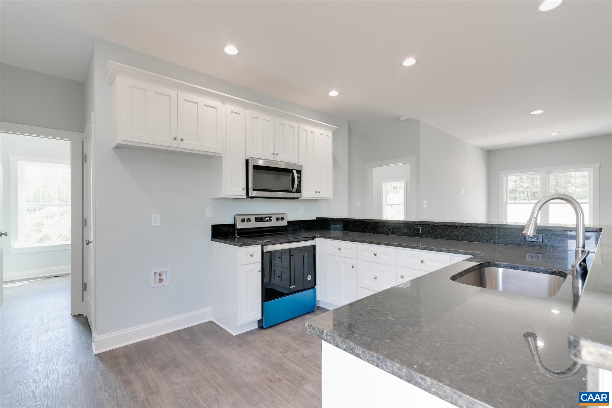 6008 Old Columbia Road Columbia, VA 23038 - Photo 7 of 23 a kitchen with stainless steel appliances granite countertop a stove a sink and a microwave