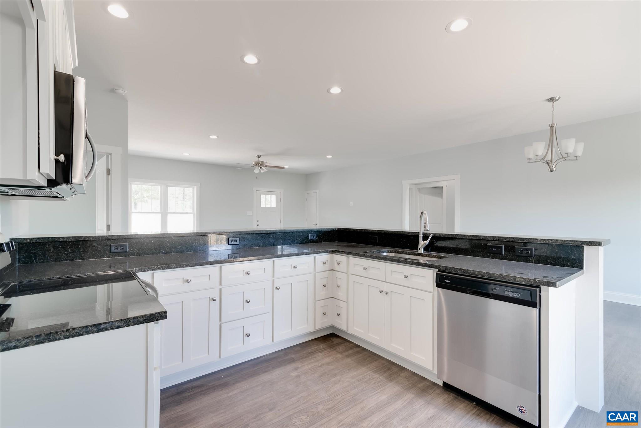 6008 Old Columbia Road Columbia, VA 23038 - Photo 9 of 23 a kitchen with granite countertop white cabinets and a sink
