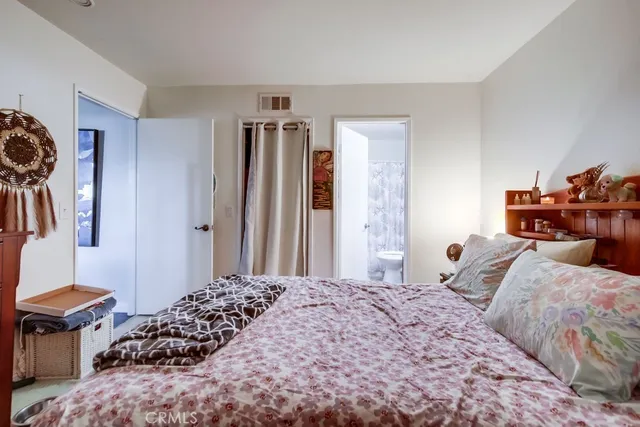 a bedroom with a bed and a closet