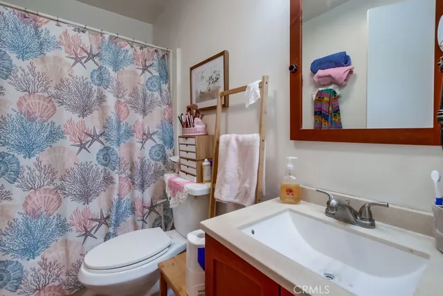 a bathroom with a toilet a sink and a mirror