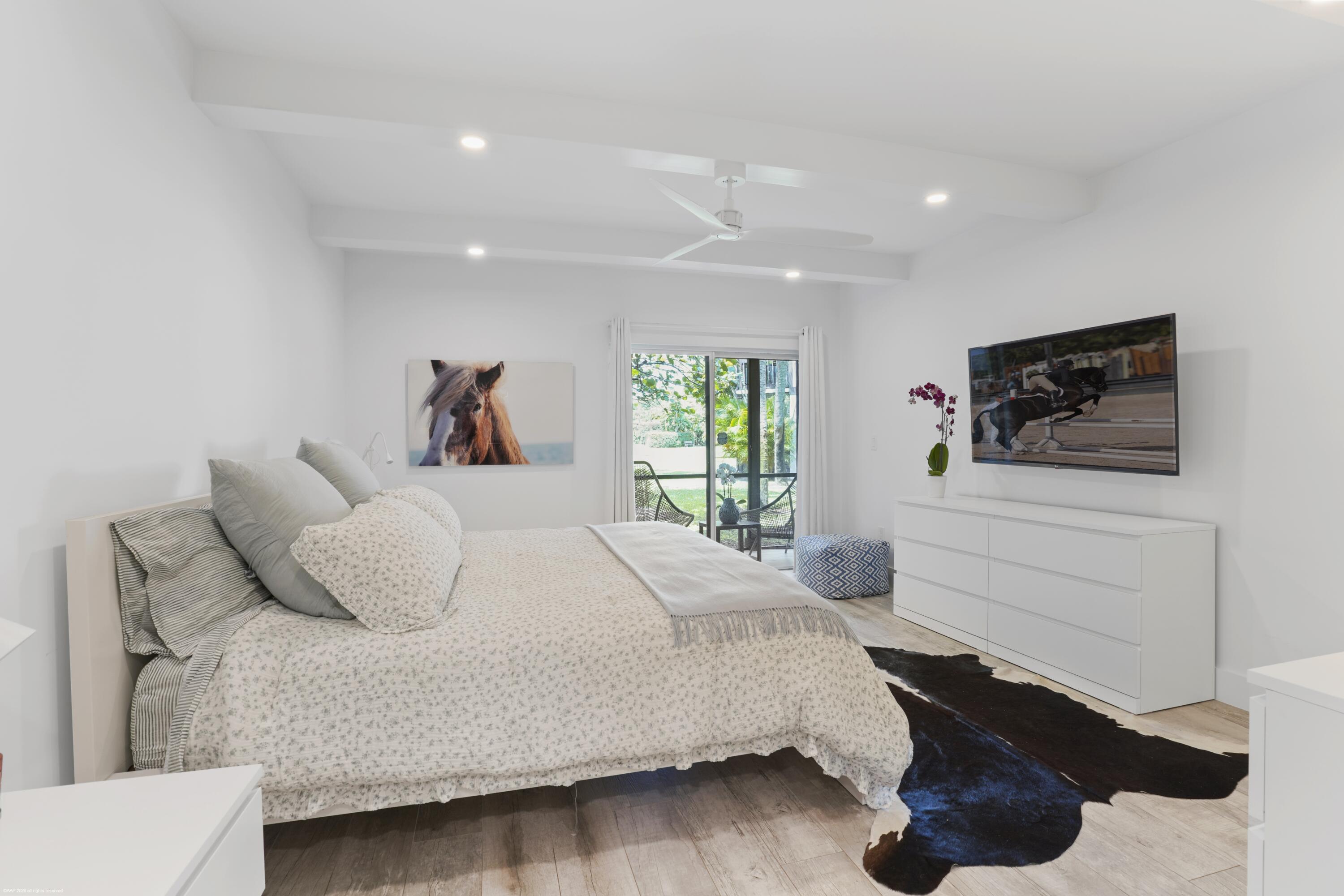 13334 Polo Club Road, Unit 234 Wellington, FL 33414 - Photo 11 of 41 a bedroom with a bed and a flat screen tv